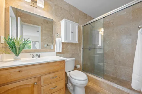 a bathroom with a sink toilet and shower