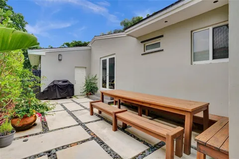 a view of a patio with chair and potted plants