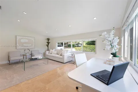 a living room with furniture rug and window