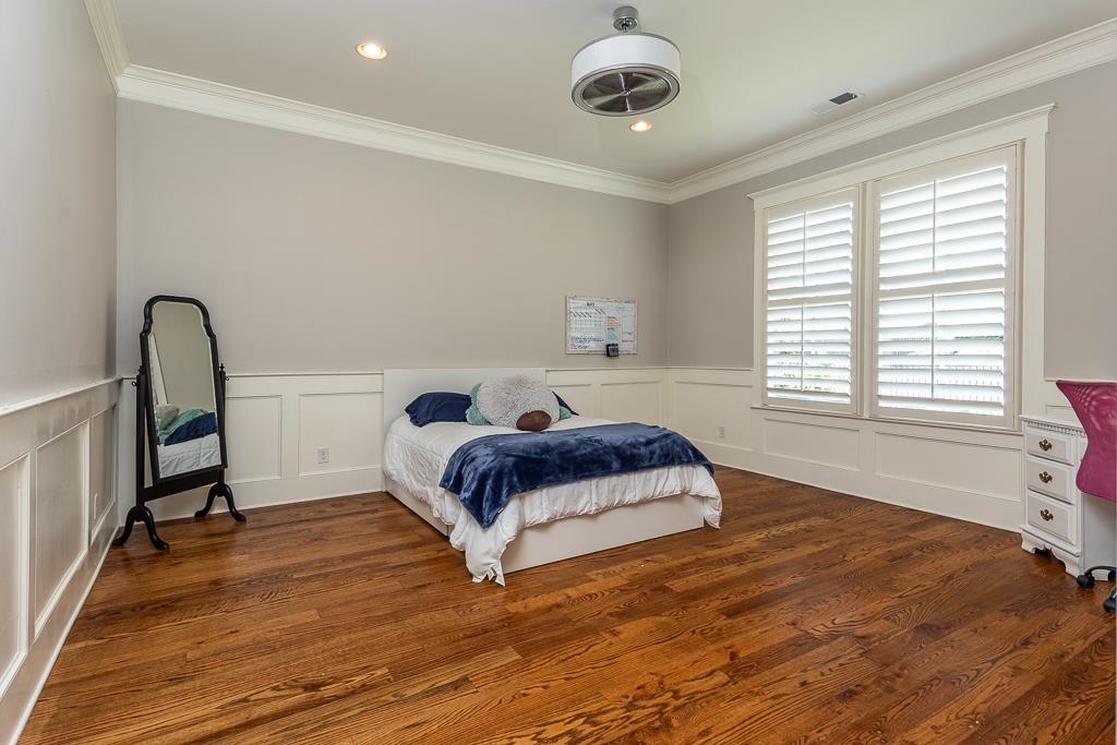 328 Washington Street Collierville, TN 38017 - Photo 20 of 33 Bright room featuring rich wood-finish flooring, white wainscoting, and crown molding