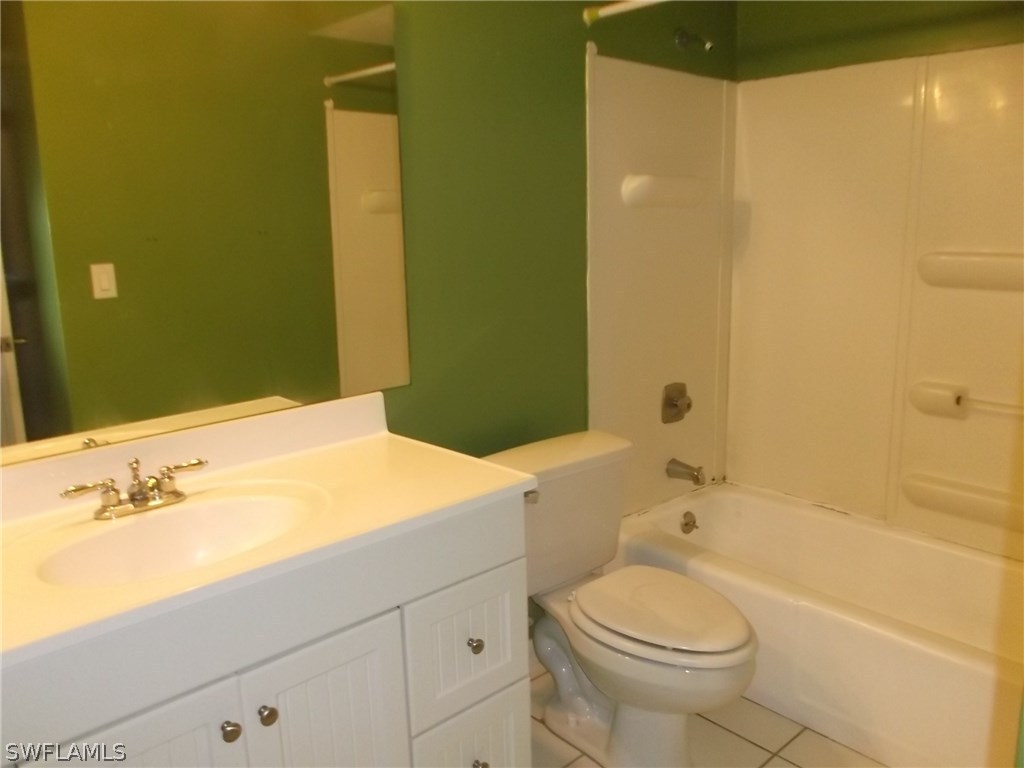 214 Davis Road Lehigh Acres, FL 33936 - Photo 8 of 11 a bathroom with a sink a toilet and shower