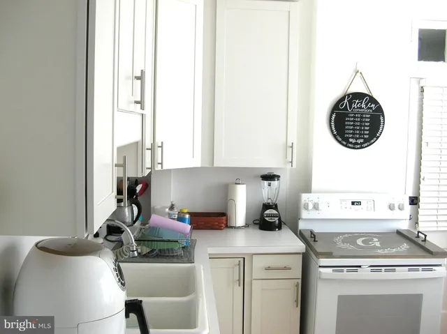 a kitchen with a stove a sink and a refrigerator