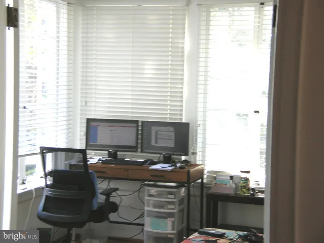a kitchen with a window and chairs