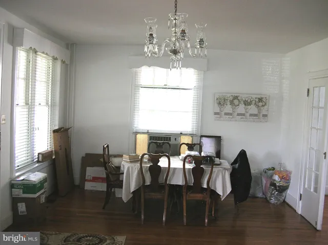 a view of a dining room with furniture and windows