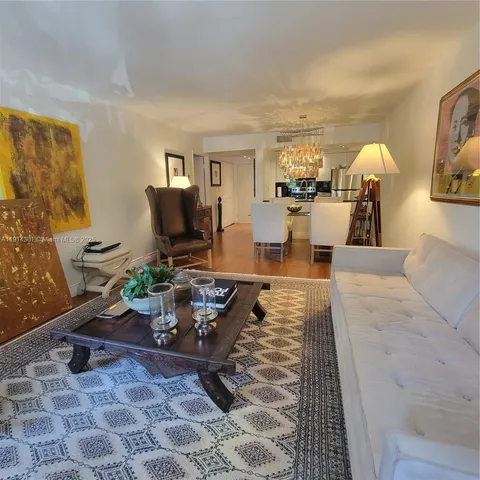 a living room with furniture and a painting on the wall