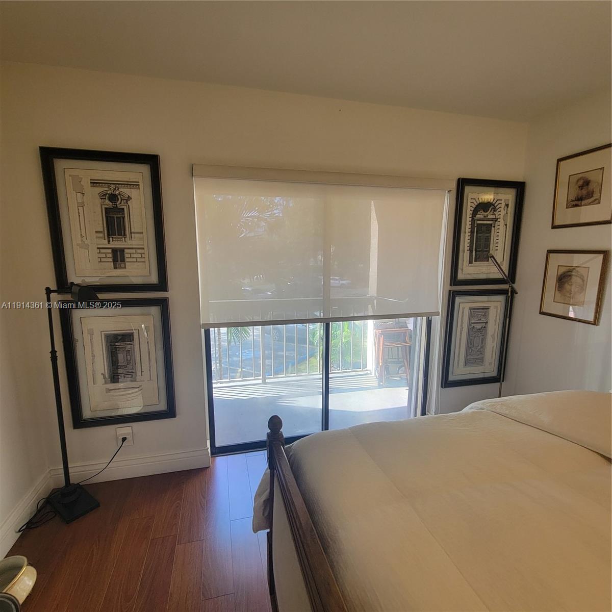 8180 Geneva Court, Unit 219 Doral, FL 33166 - Photo 17 of 19 a bedroom with a bed and a large window