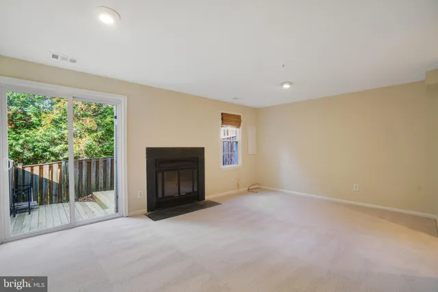 a view of a house with backyard and wooden fence