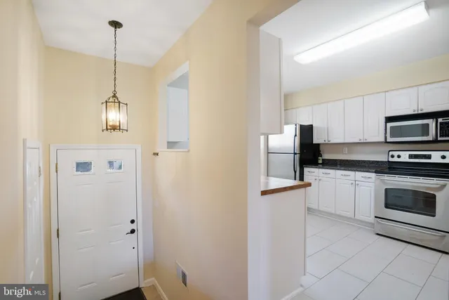 a kitchen with stainless steel appliances granite countertop a refrigerator a sink and a stove