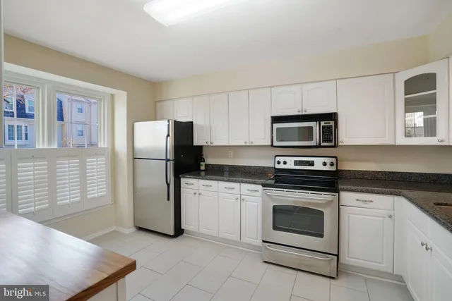 a kitchen with a stove microwave and refrigerator
