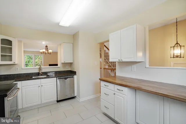a kitchen with stainless steel appliances granite countertop a sink and cabinets