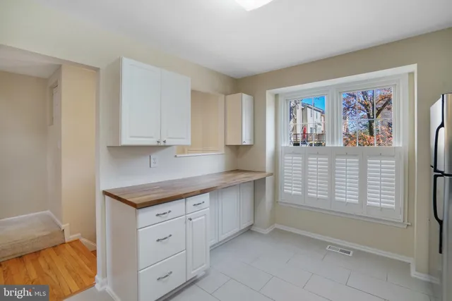 a kitchen with stainless steel appliances granite countertop a sink and dishwasher with white cabinets