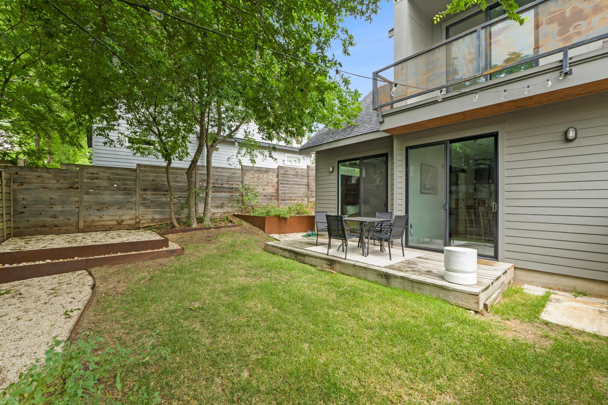 1706 Perez Street, Unit 2 Austin, TX 78721 - Photo 27 of 29 A private rear yard offers a wooden deck for outdoor dining and layered landscaping.