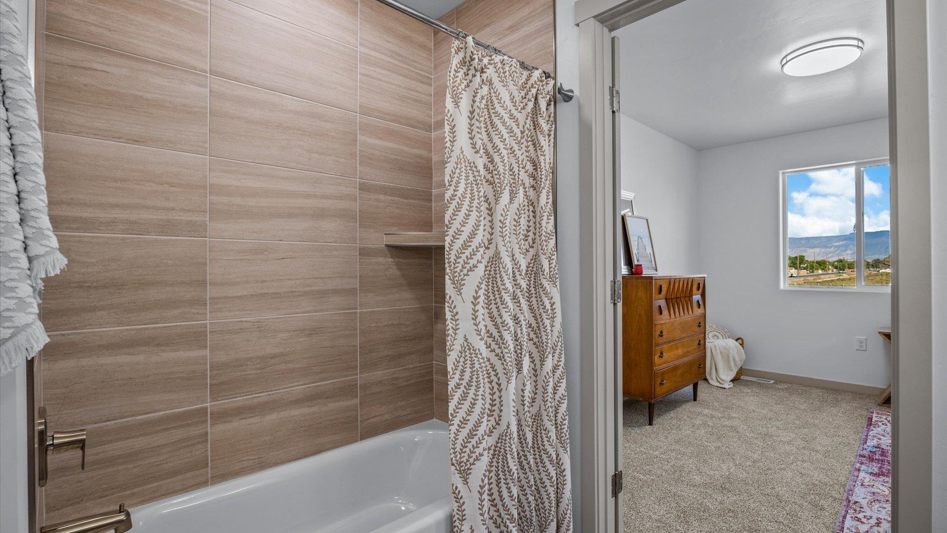 2786 Caspian Way, Unit A Grand Junction, CO 81503 - Photo 15 of 42 a bathroom with a shower and a tub