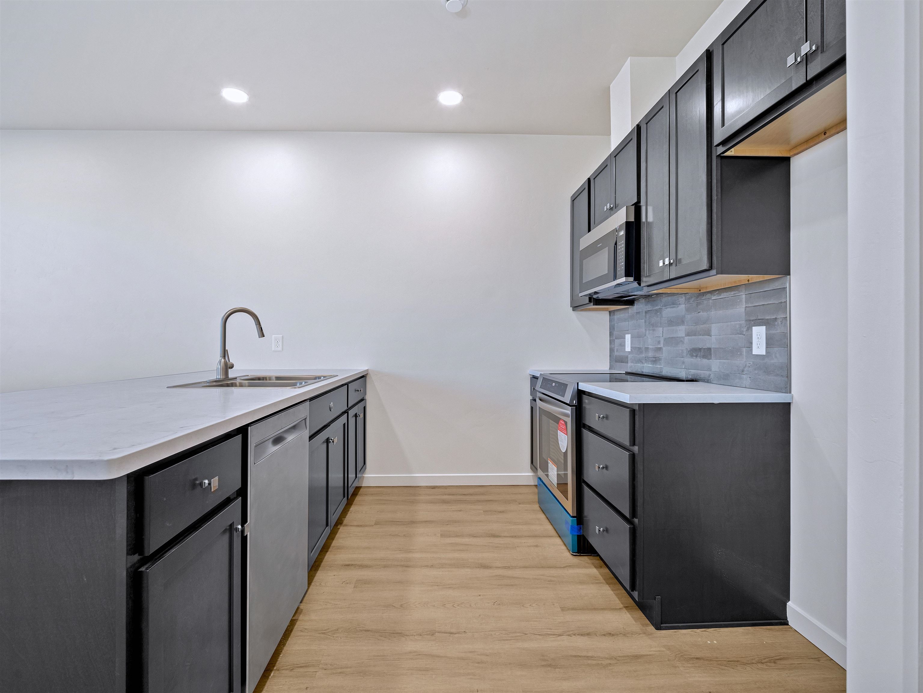 2786 Caspian Way, Unit A Grand Junction, CO 81503 - Photo 28 of 42 a kitchen with stainless steel appliances granite countertop a sink and stove top oven