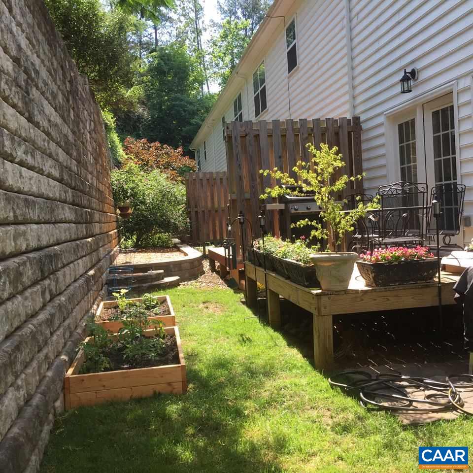 343 Quarry Road Charlottesville, VA 22902 - Photo 19 of 34 a view of a backyard with chairs and a potted plant