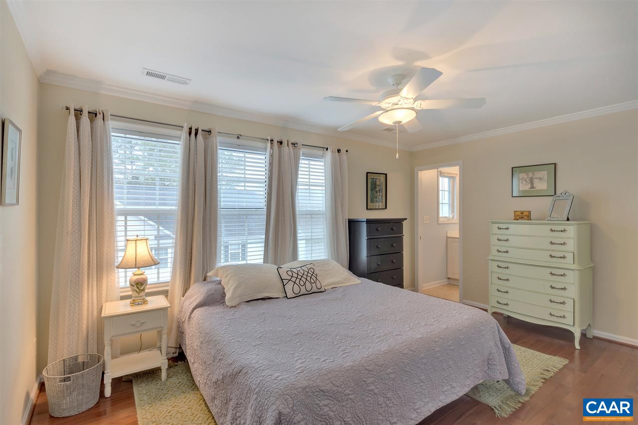 343 Quarry Road Charlottesville, VA 22902 - Photo 23 of 34 a spacious bedroom with a large bed and a chandelier
