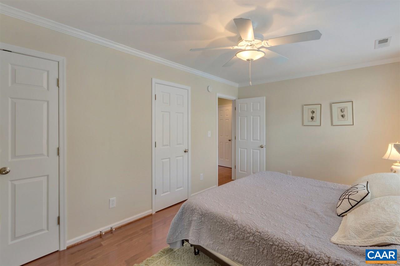 343 Quarry Road Charlottesville, VA 22902 - Photo 24 of 34 a bedroom with a bed and a chandelier