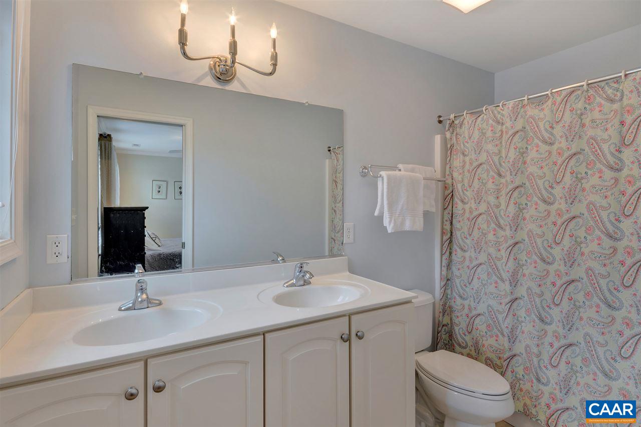 343 Quarry Road Charlottesville, VA 22902 - Photo 25 of 34 a bathroom with a granite countertop sink a toilet and a mirror