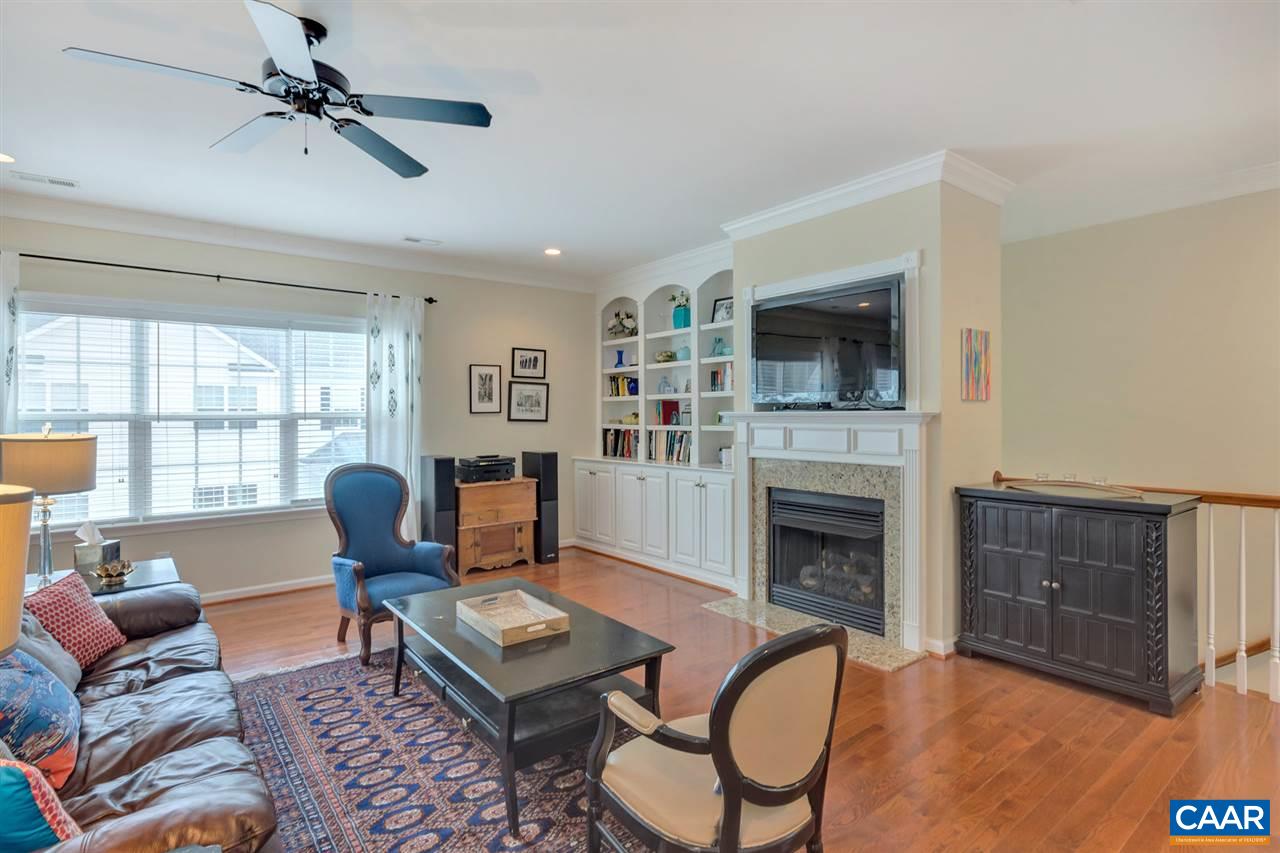 343 Quarry Road Charlottesville, VA 22902 - Photo 5 of 34 a living room with furniture a flat screen tv and a fireplace