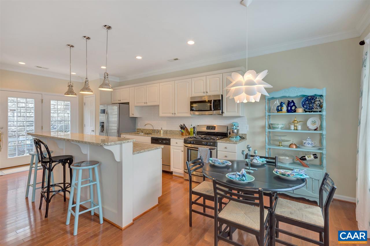 343 Quarry Road Charlottesville, VA 22902 - Photo 7 of 34 a kitchen with stainless steel appliances granite countertop a dining table chairs stove a microwave and a view of living room