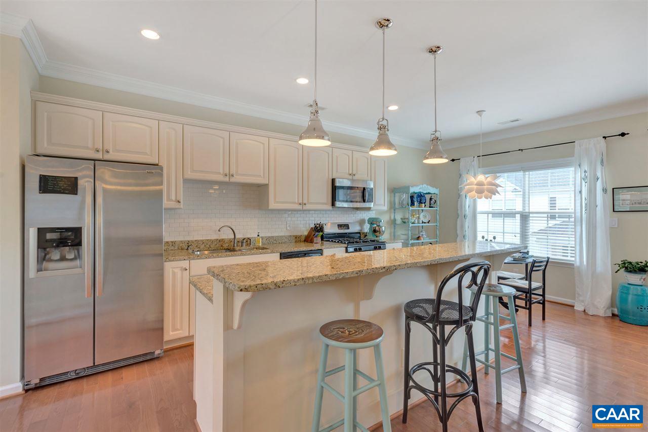 343 Quarry Road Charlottesville, VA 22902 - Photo 8 of 34 a kitchen with stainless steel appliances granite countertop a stove a refrigerator a kitchen island a sink and a refrigerator