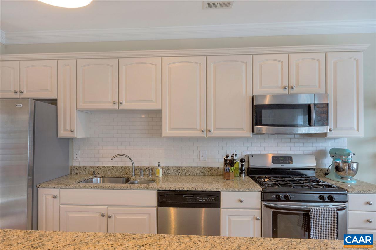 343 Quarry Road Charlottesville, VA 22902 - Photo 9 of 34 a kitchen with granite countertop white cabinets and stainless steel appliances