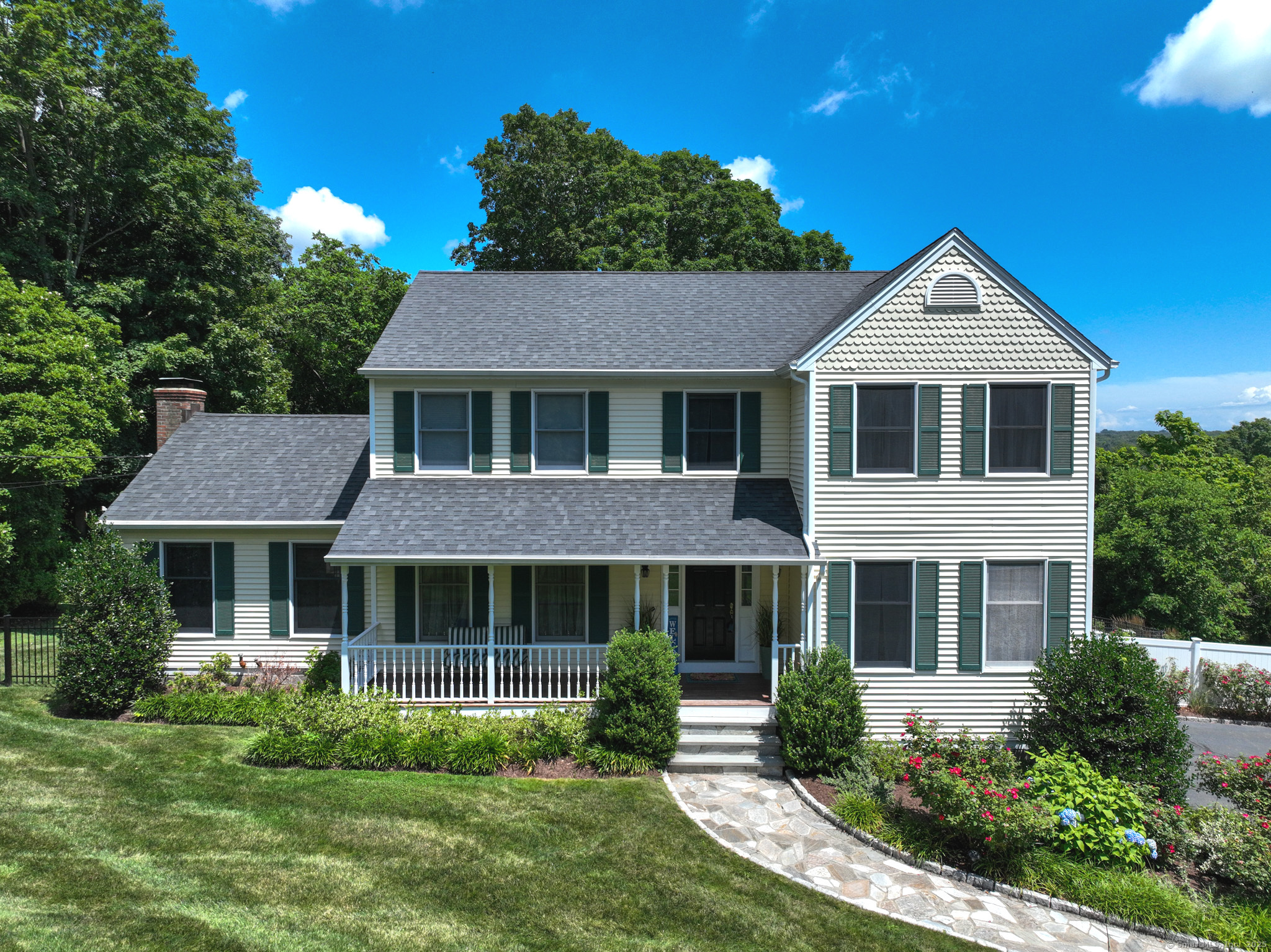 803 Grassy Hill Road Orange, CT 06477 - Photo 1 of 1 a front view of a house with garden and porch