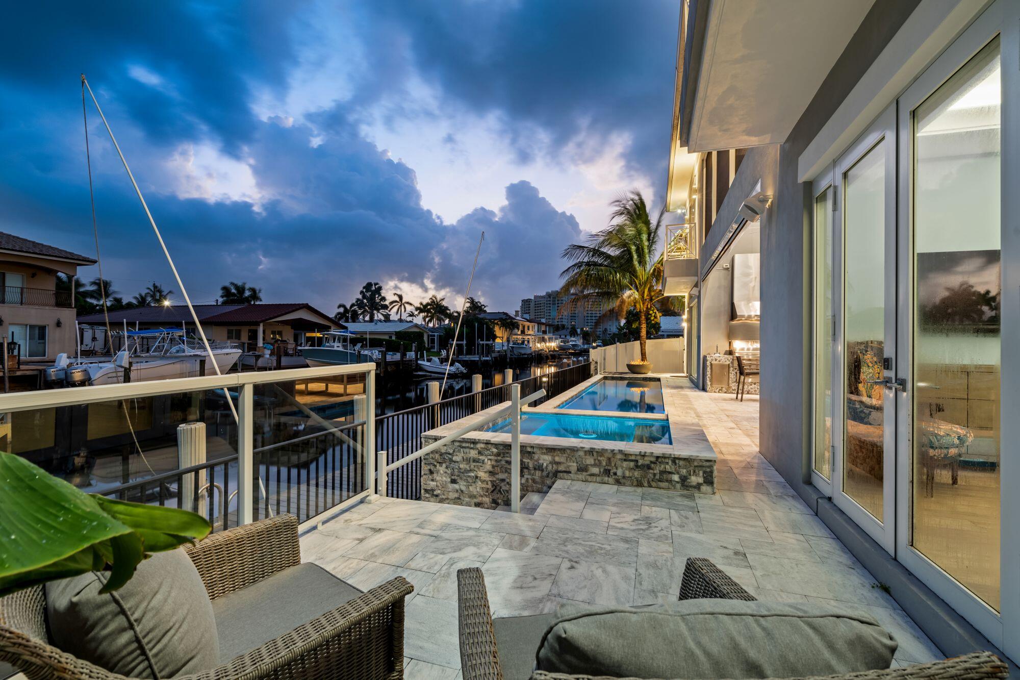 807 Dover Street Boca Raton, FL 33487 - Photo 36 of 47 a view of a patio with couches and table and chairs with wooden floor