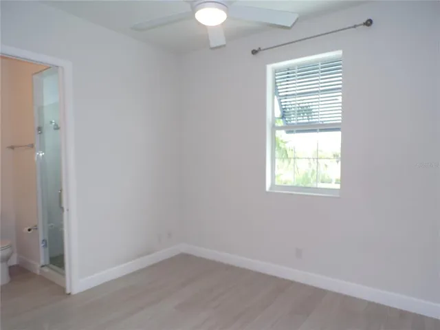 a view of a livingroom with a ceiling fan and window