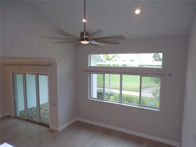 a open kitchen with white cabinets and chandelier