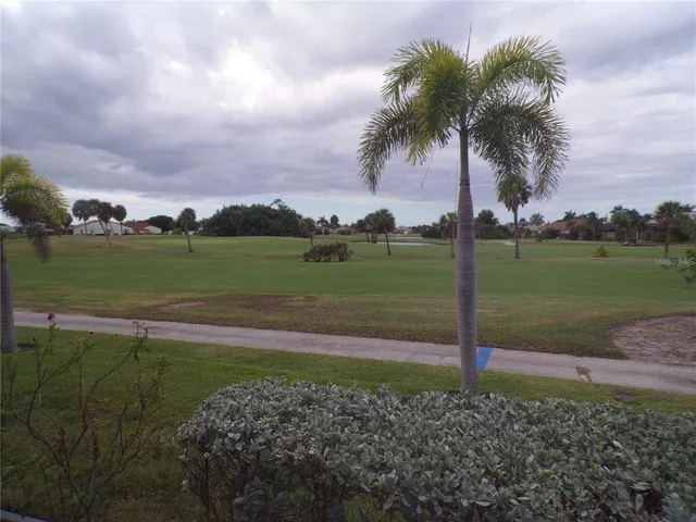 a kitchen with stainless steel appliances granite countertop a sink a stove and a wooden floors
