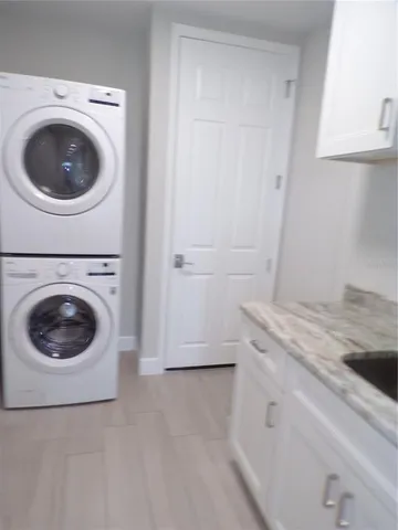 a kitchen with granite countertop white cabinets and stainless steel appliances