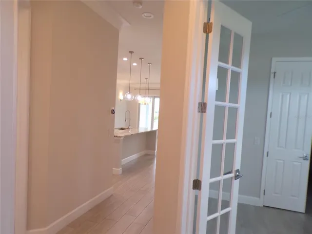 a view of a house with a yard plants and palm trees
