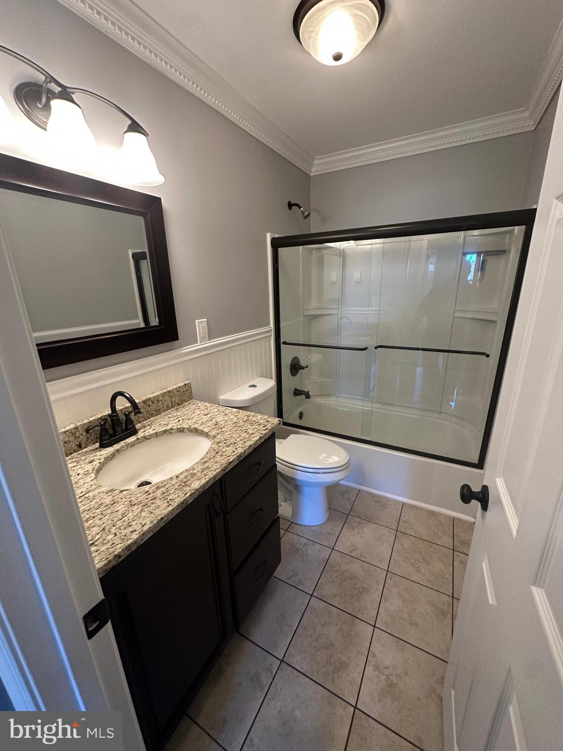 3457 Baker Road Westminster, MD 21157 - Photo 46 of 105 a bathroom with a granite countertop sink toilet and mirror
