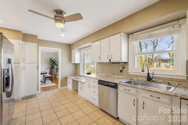 a kitchen with a sink window and cabinets