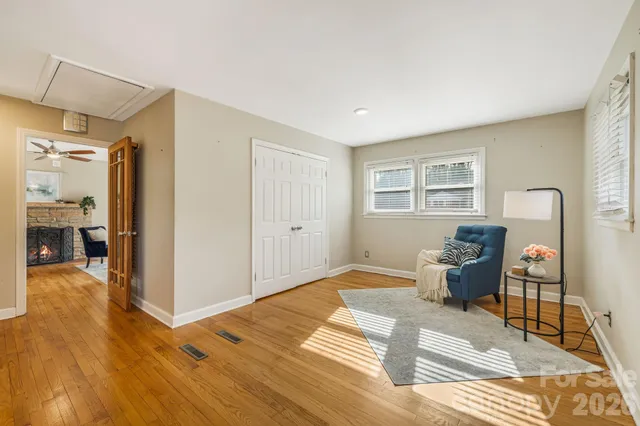 a living room with furniture a dining table and wooden floor