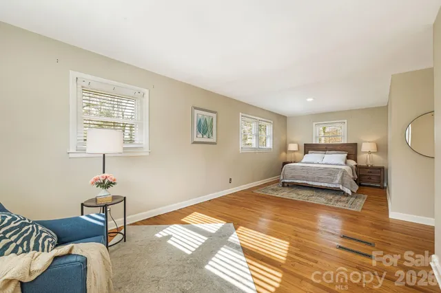 a bedroom with a bed and a lamp on table