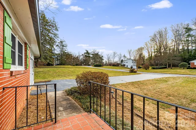 a view of swimming pool with outdoor seating and yard in the back