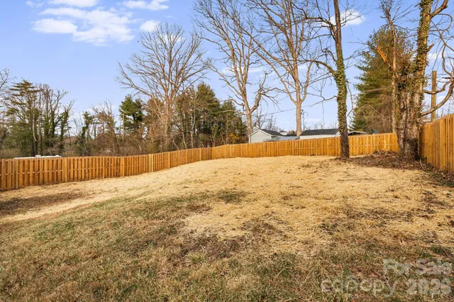 a view of yard covered with snow in front of house