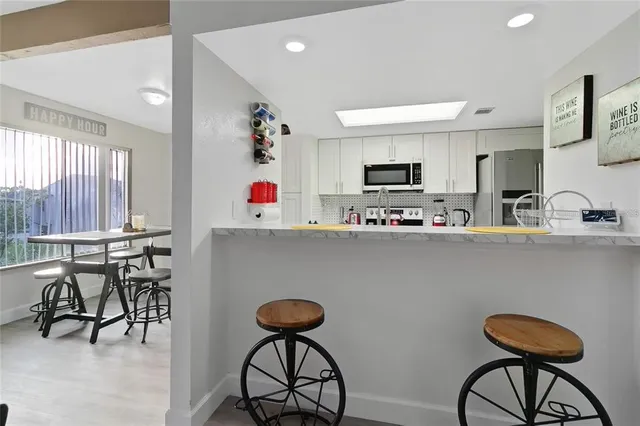 a kitchen with a sink cabinets and appliances