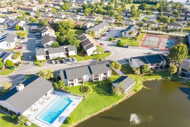 an aerial view of residential houses with outdoor space