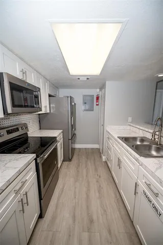 a stove top oven sitting inside of a kitchen