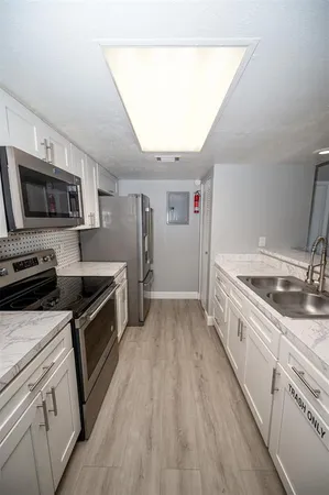 a stove top oven sitting inside of a kitchen