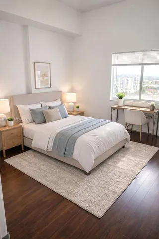 a bedroom with a bed a table and three large window