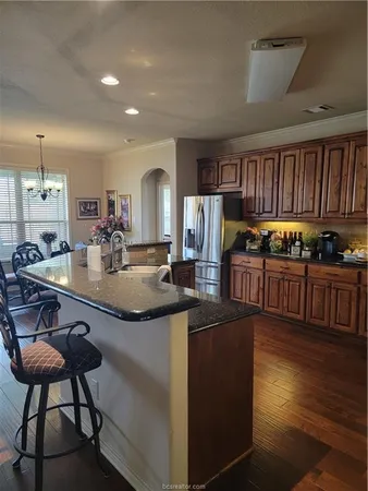 a kitchen with kitchen island granite countertop lots of counter top space and stainless steel appliances