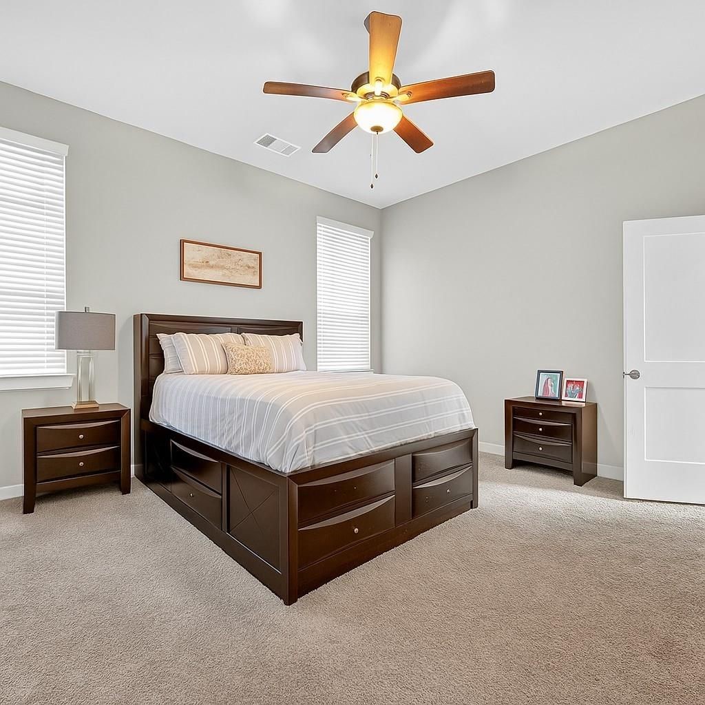 12154 Texas Trumpet Trail Humble, TX 77346 - Photo 11 of 21 a bedroom with a bed and a chandelier