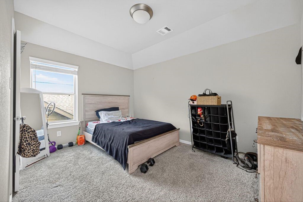 12154 Texas Trumpet Trail Humble, TX 77346 - Photo 14 of 21 a bedroom with a bed and a window