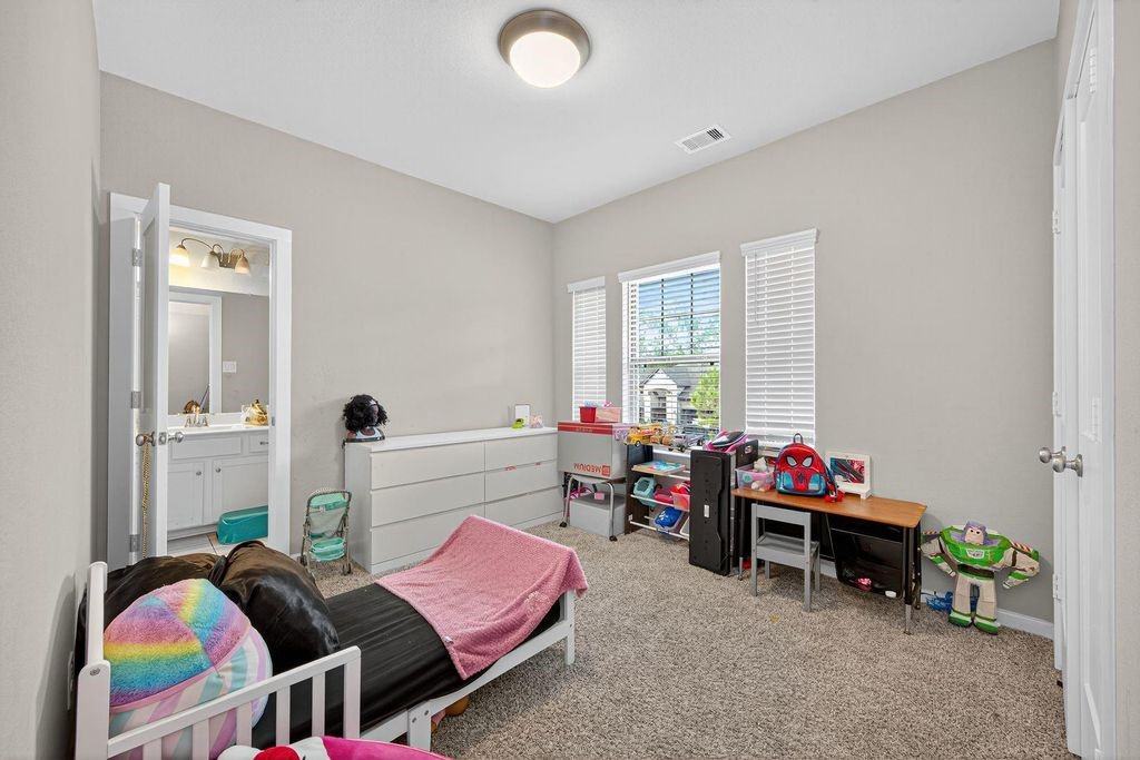 12154 Texas Trumpet Trail Humble, TX 77346 - Photo 16 of 21 a bedroom with furniture and a window