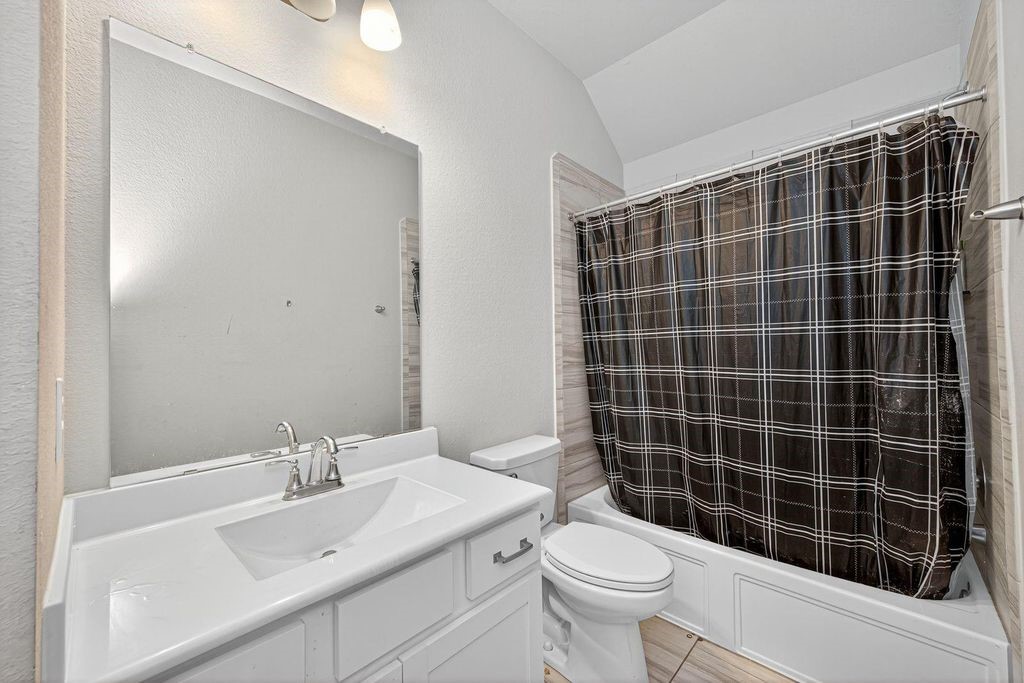 12154 Texas Trumpet Trail Humble, TX 77346 - Photo 17 of 21 a bathroom with a sink toilet and shower