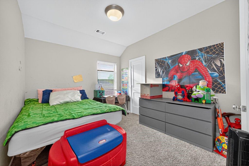 12154 Texas Trumpet Trail Humble, TX 77346 - Photo 18 of 21 a room with furniture and a flat screen tv